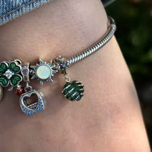 Sterling silver skeleton heart charm with emerald crystal and gothic details.