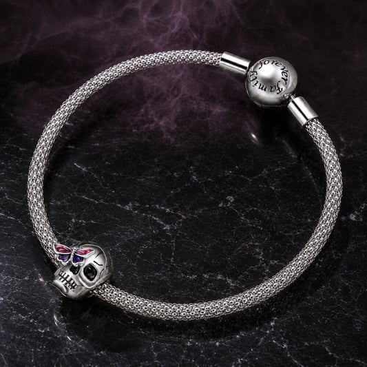 Sterling silver skull charm with purple butterfly and black enamel details.