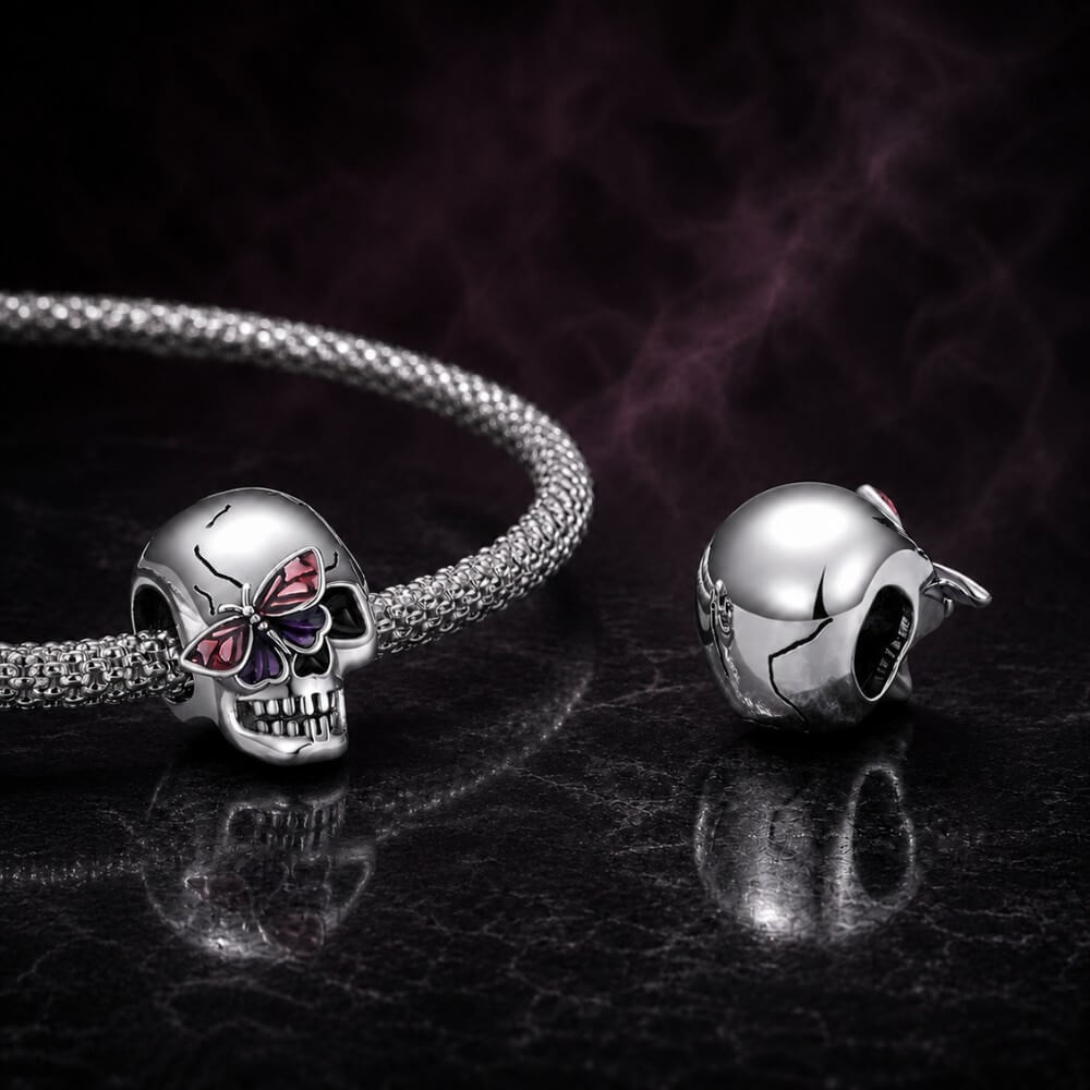 Sterling silver skull charm with purple butterfly and black enamel details.
