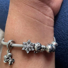 Sterling silver snowflake charm with clear crystal stones.