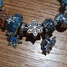 Sterling silver snowflake charm with clear crystal stones.