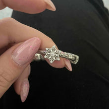 Sterling silver snowflake charm with clear crystal stones.