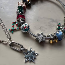 Sterling silver snowflake charm with clear crystal stones.