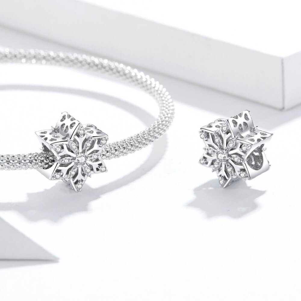 Sterling silver snowflake charm with clear crystal stones.