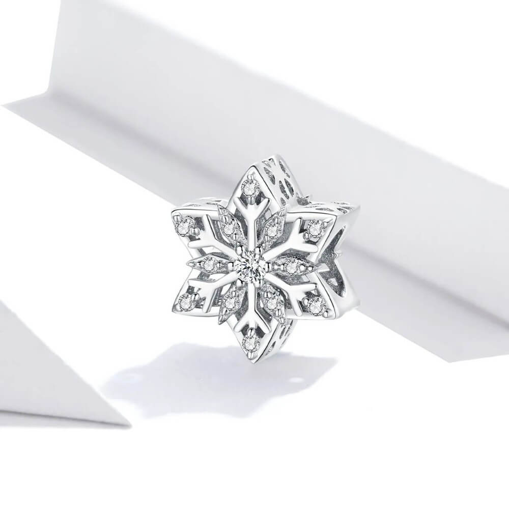 Sterling silver snowflake charm with clear crystal stones.