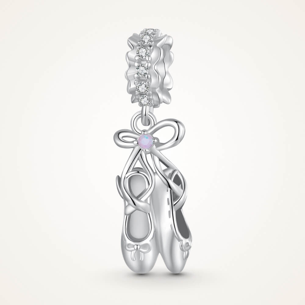 Sterling silver ballet shoes charm with delicate bow and soft pink opalescent detail - ORÉYA