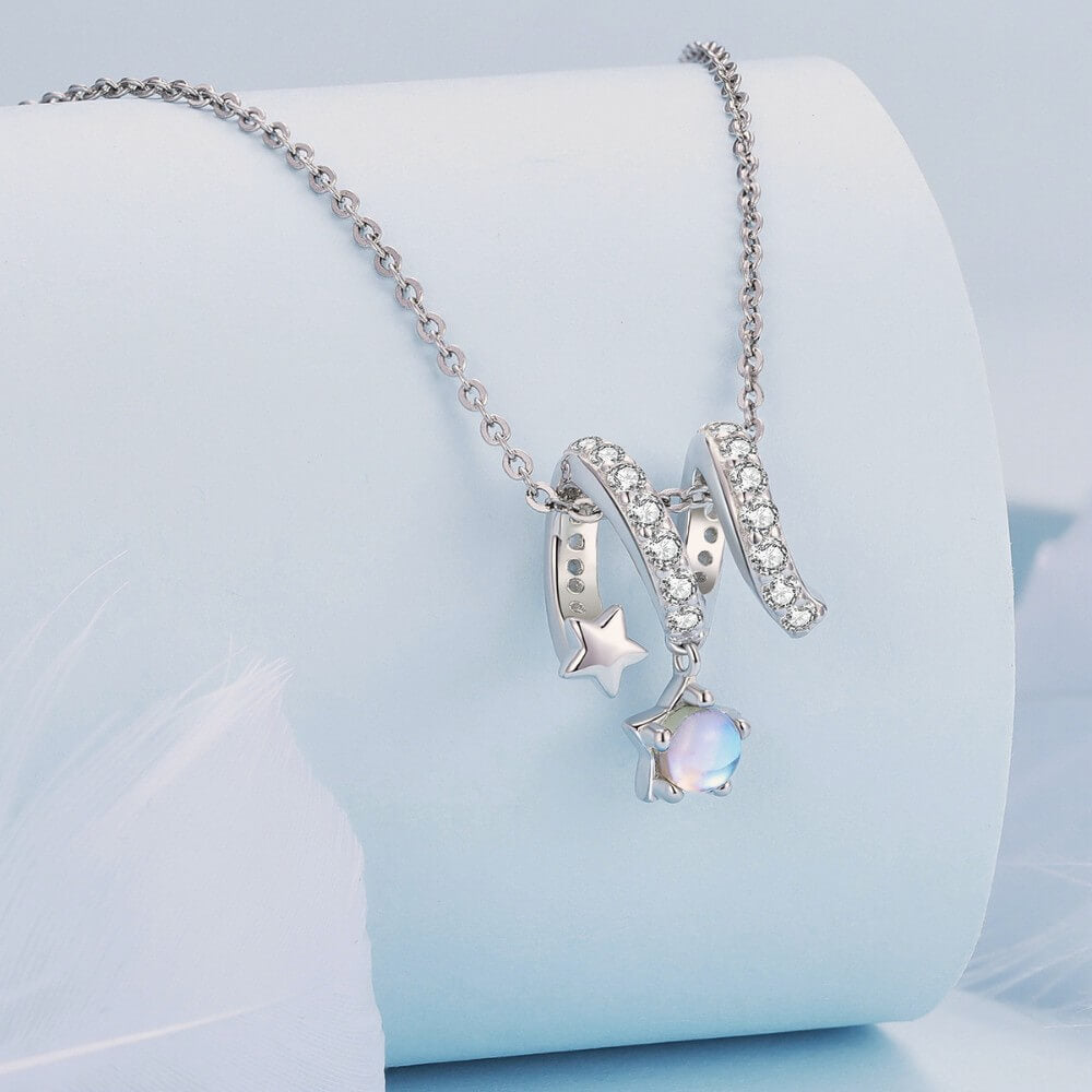 Sterling silver swirl charm with star details and iridescent dangling crystal.