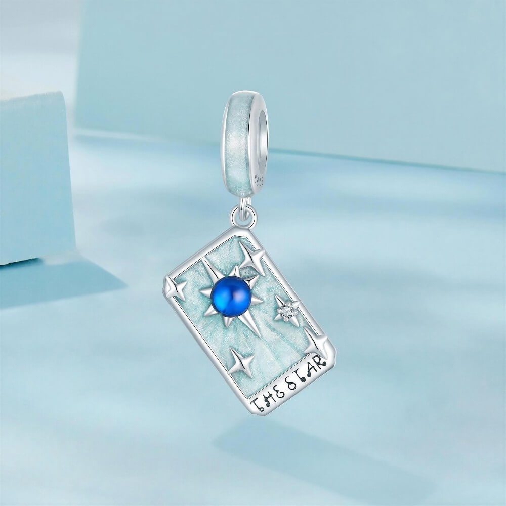 Sterling silver star tarot charm with blue crystal and mint enamel details.