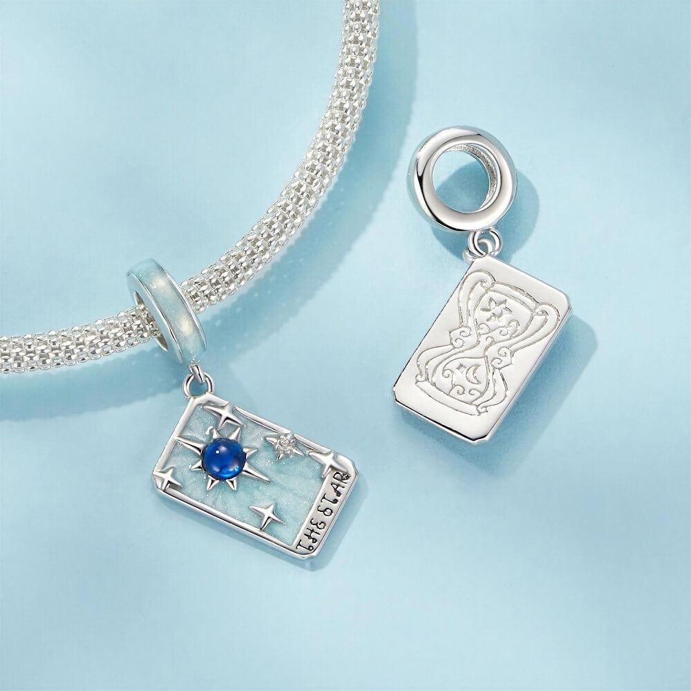 Sterling silver star tarot charm with blue crystal and mint enamel details.