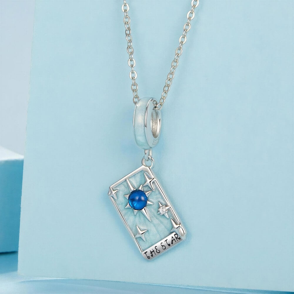 Sterling silver star tarot charm with blue crystal and mint enamel details.
