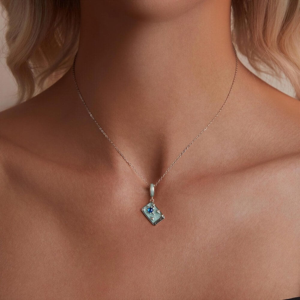 Sterling silver star tarot charm with blue crystal and mint enamel details.