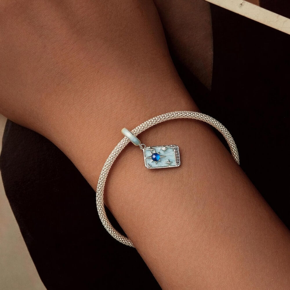 Sterling silver star tarot charm with blue crystal and mint enamel details.