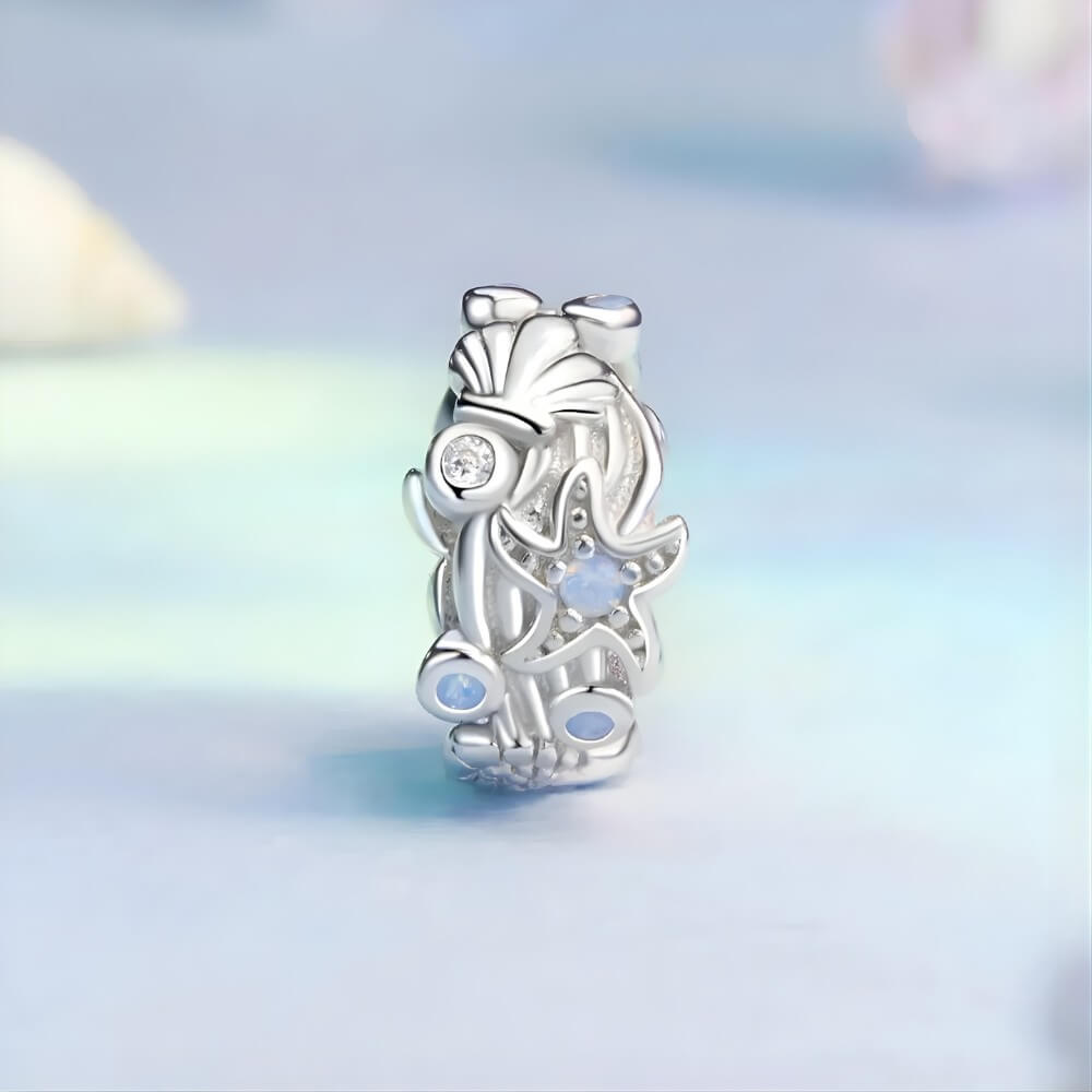 Sterling silver ocean charm with starfish and opal crystal accents.