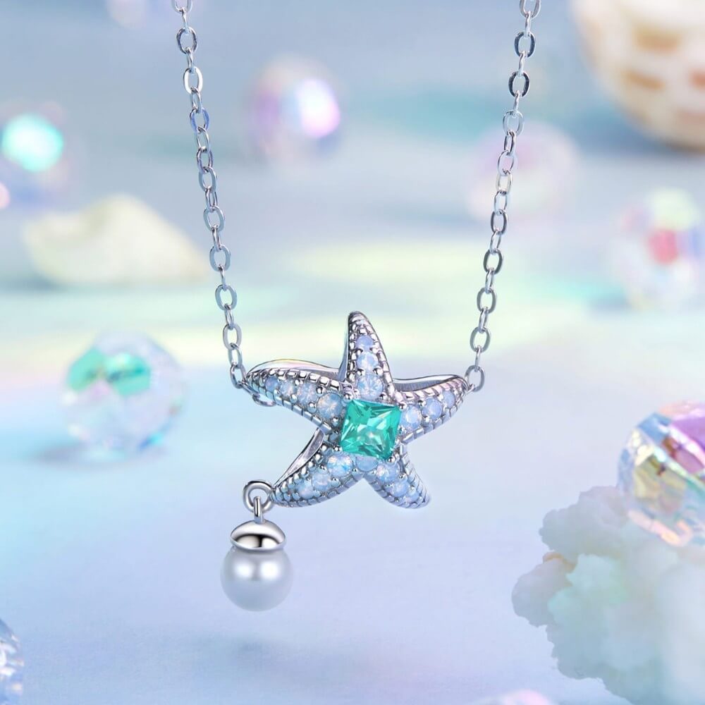 Sterling silver starfish charm with green crystal, opal stones, and pearl.