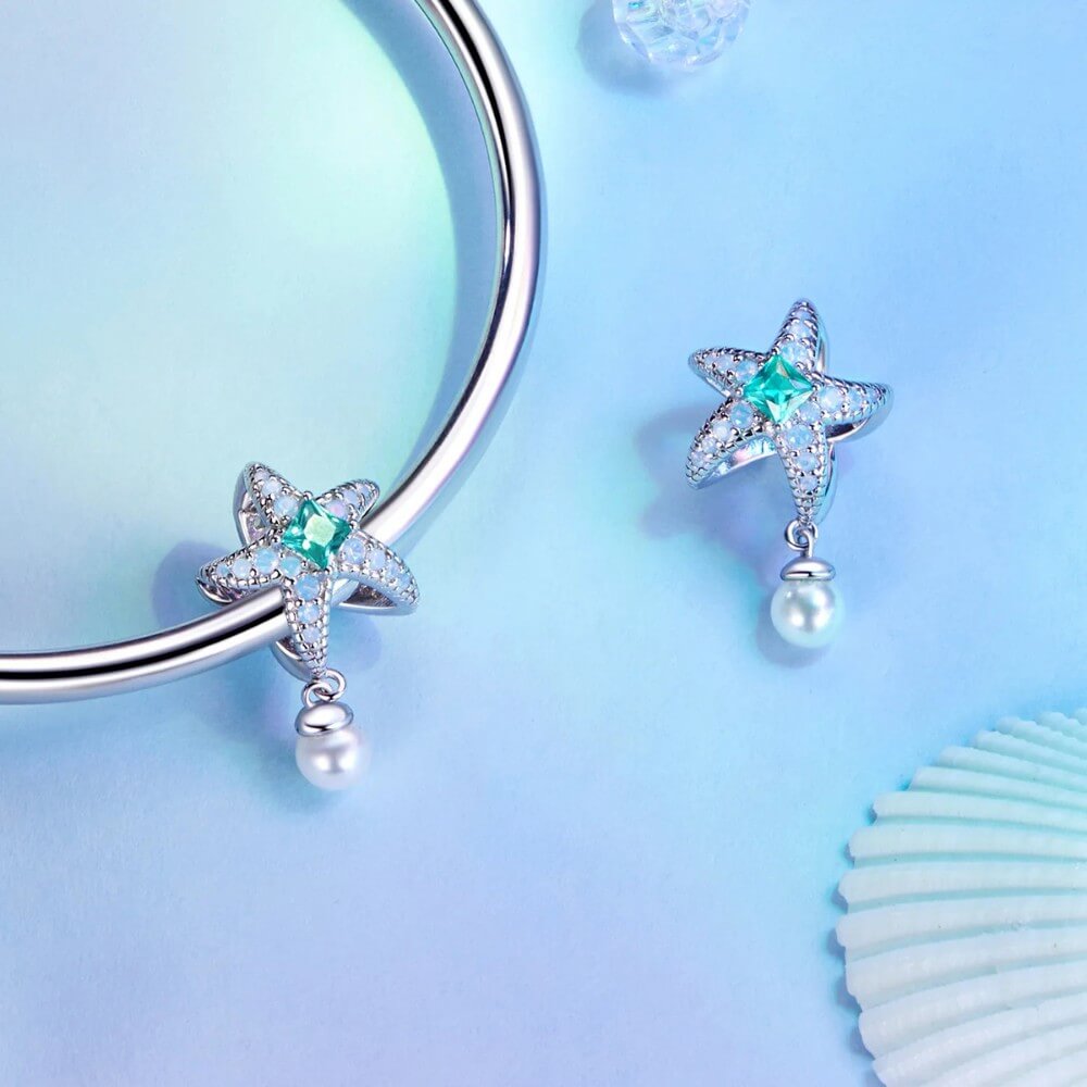 Sterling silver starfish charm with green crystal, opal stones, and pearl.