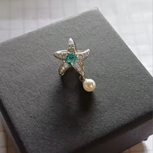 Sterling silver starfish charm with green crystal, opal stones, and pearl.