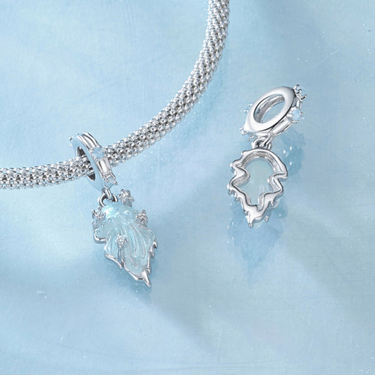 Sterling silver jellyfish dangle charm with iridescent enamel body, flowing tentacle design, and small clear gemstones on the bail and charm 