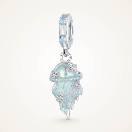 Sterling silver jellyfish dangle charm with iridescent enamel body, flowing tentacle design, and small clear gemstones on the bail and charm – ORÉYA
