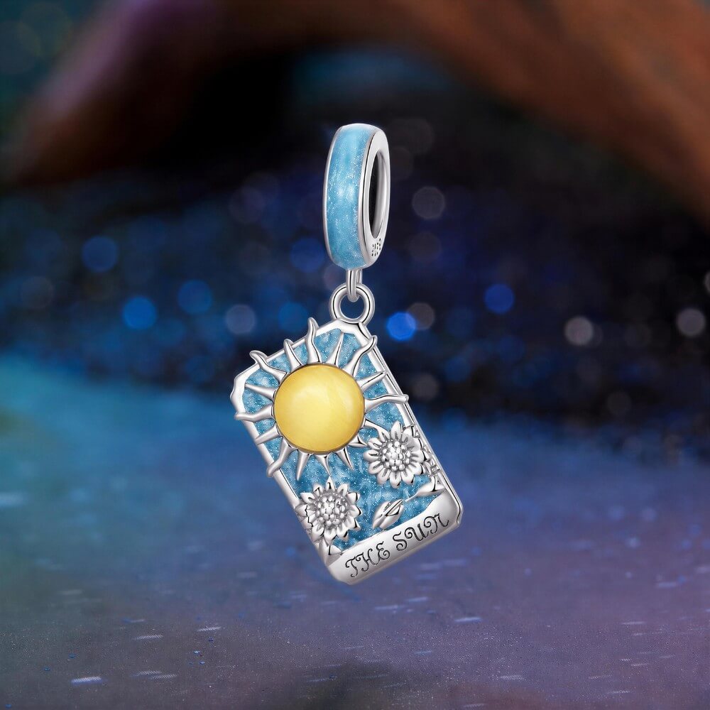 Sterling silver sun tarot charm with blue enamel and sunflower details.