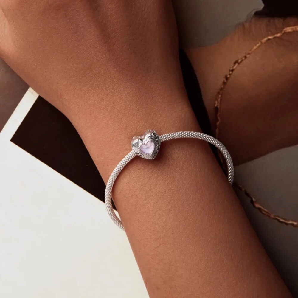 Sterling silver swan heart charm with pink crystal and pavé border.