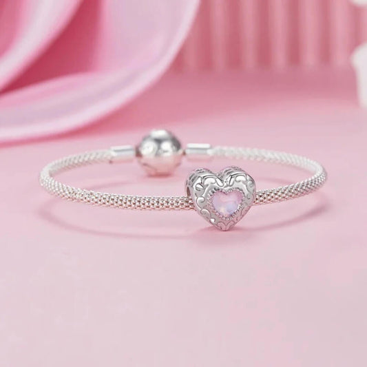 Sterling silver swan heart charm with pink crystal and pavé border.
