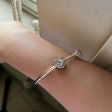 Sterling silver swan heart charm with pink crystal and pavé border.