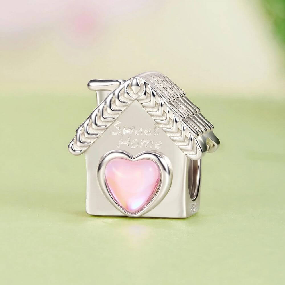 Sterling silver house charm with pink heart window, Sweet Home engraving, and detailed roof accents.