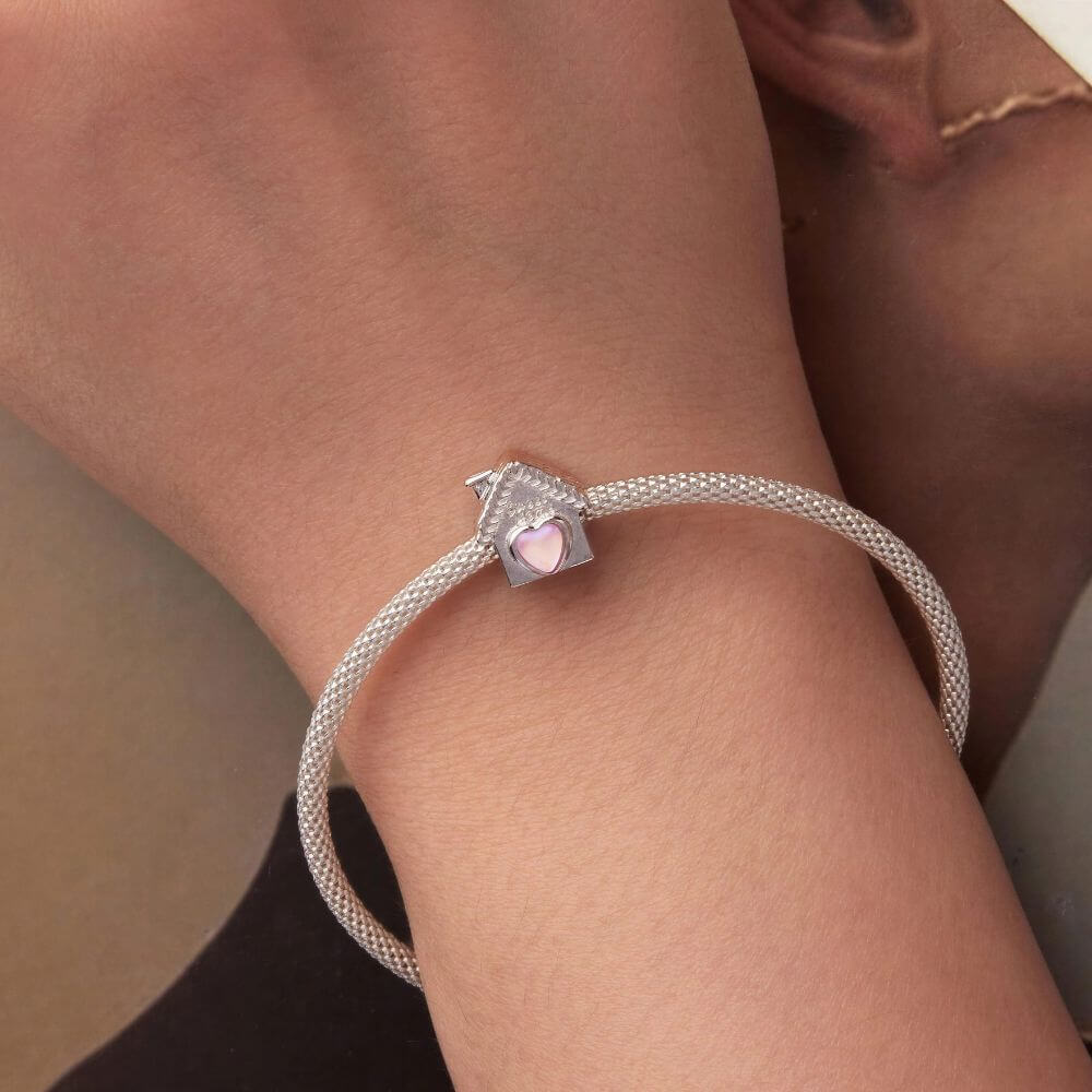 Sterling silver house charm with pink heart window, Sweet Home engraving, and detailed roof accents.