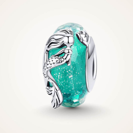 Sterling silver mermaid charm wrapped around teal faceted glass bead with textured details - ORÉYA