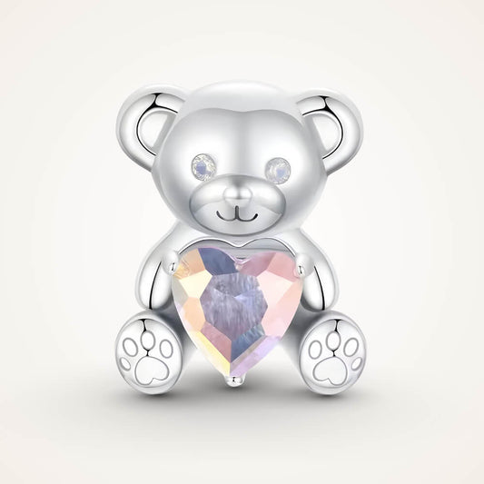 Sterling silver teddy bear charm holding an iridescent heart-shaped crystal with paw-print feet – ORÉYA