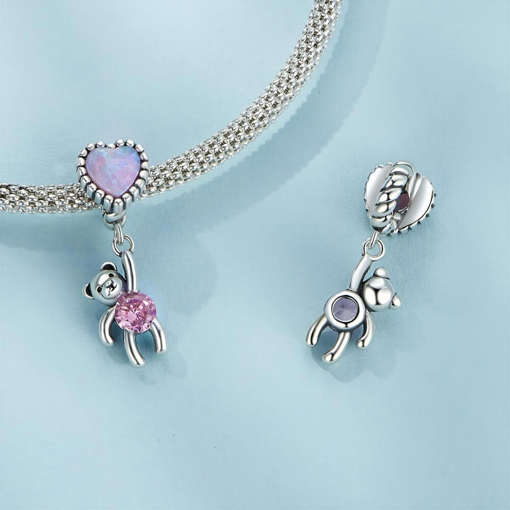 Sterling silver teddy bear charm with opal heart balloon and pink crystal.