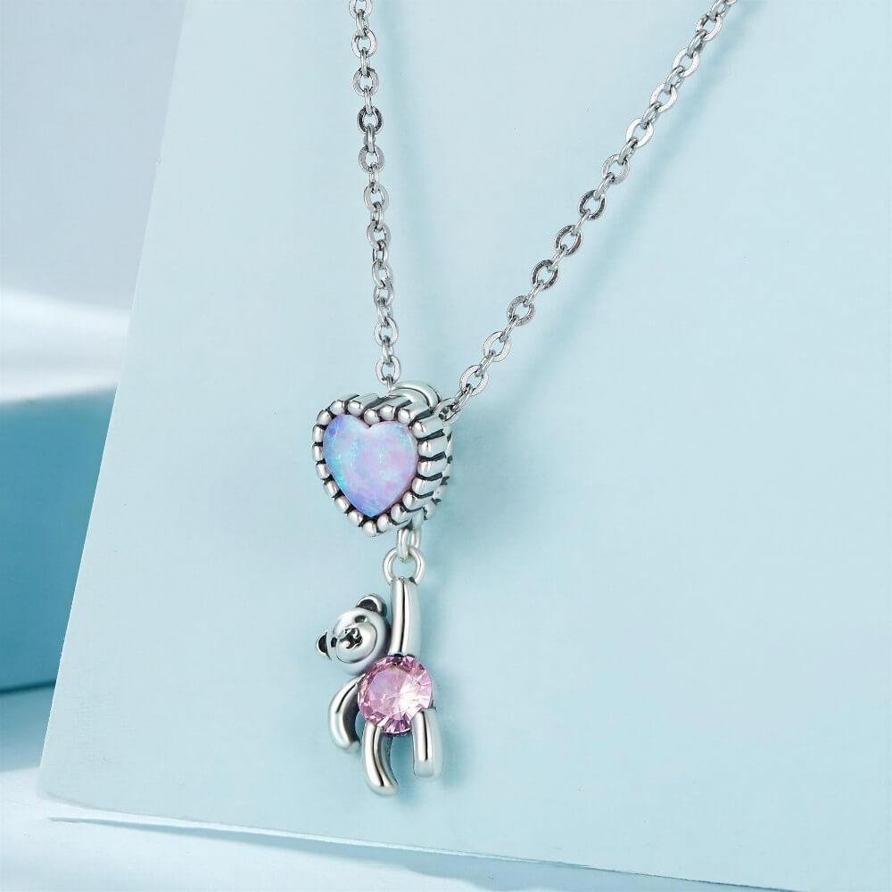 Sterling silver teddy bear charm with opal heart balloon and pink crystal.