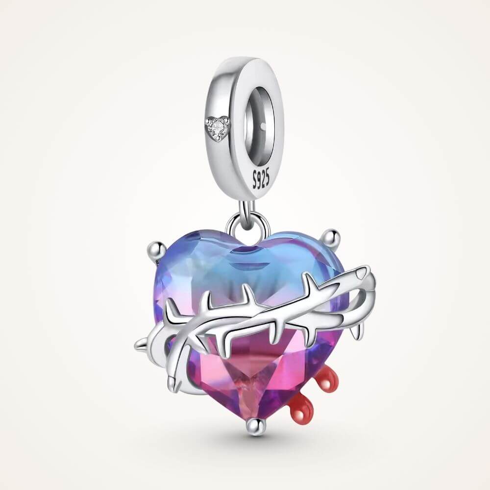 Sterling silver heart charm with blue pink crystal, thorned vine detail, and red drop accents - ORÉYA