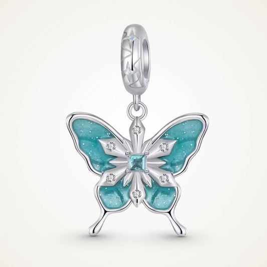Sterling silver butterfly charm with turquoise enamel and crystal snowflake details.