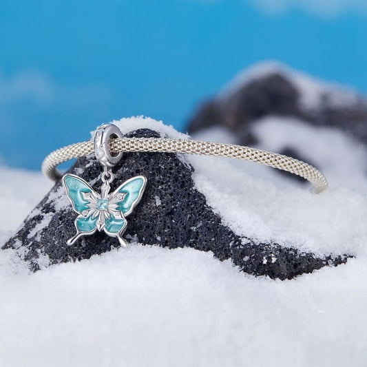 Sterling silver butterfly charm with turquoise enamel and crystal snowflake details.