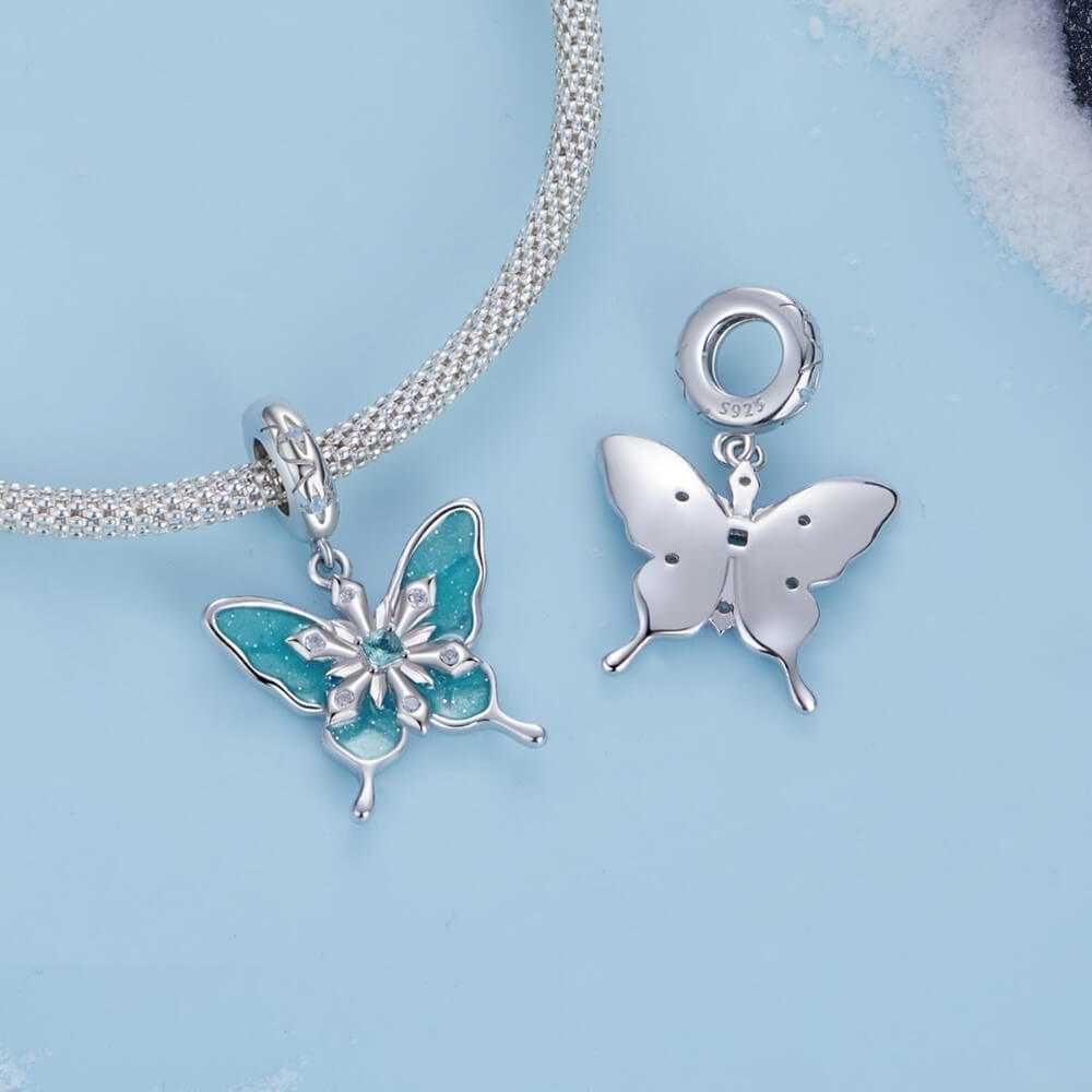 Sterling silver butterfly charm with turquoise enamel and crystal snowflake details.