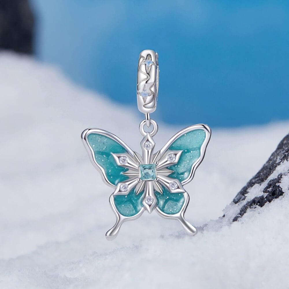 Sterling silver butterfly charm with turquoise enamel and crystal snowflake details.