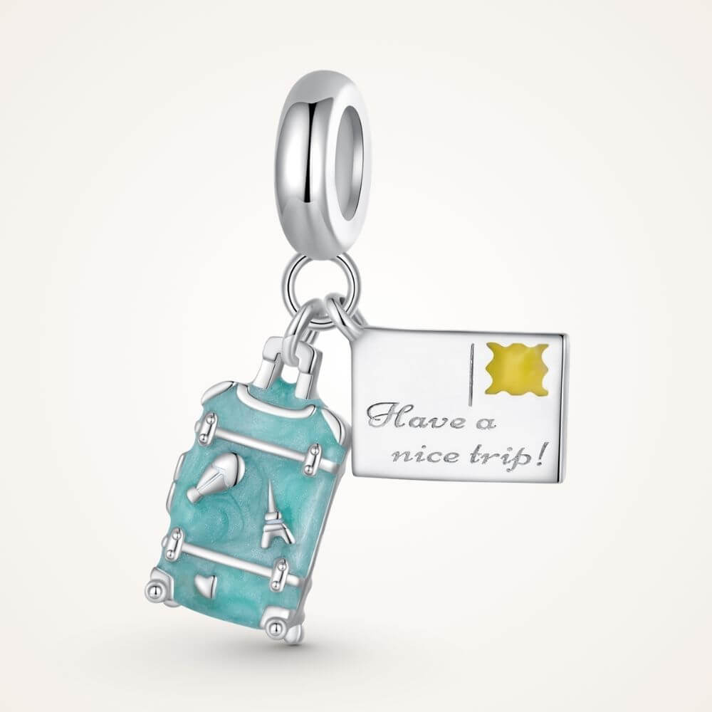 Sterling silver travel charm with turquoise suitcase, postcard, Eiffel Tower, and airplane-inspired details - ORÉYA