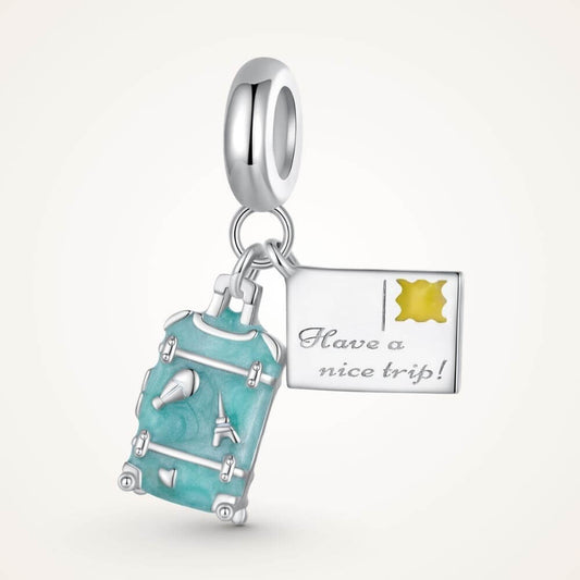 Sterling silver travel charm with turquoise suitcase, postcard, Eiffel Tower, and airplane-inspired details - ORÉYA