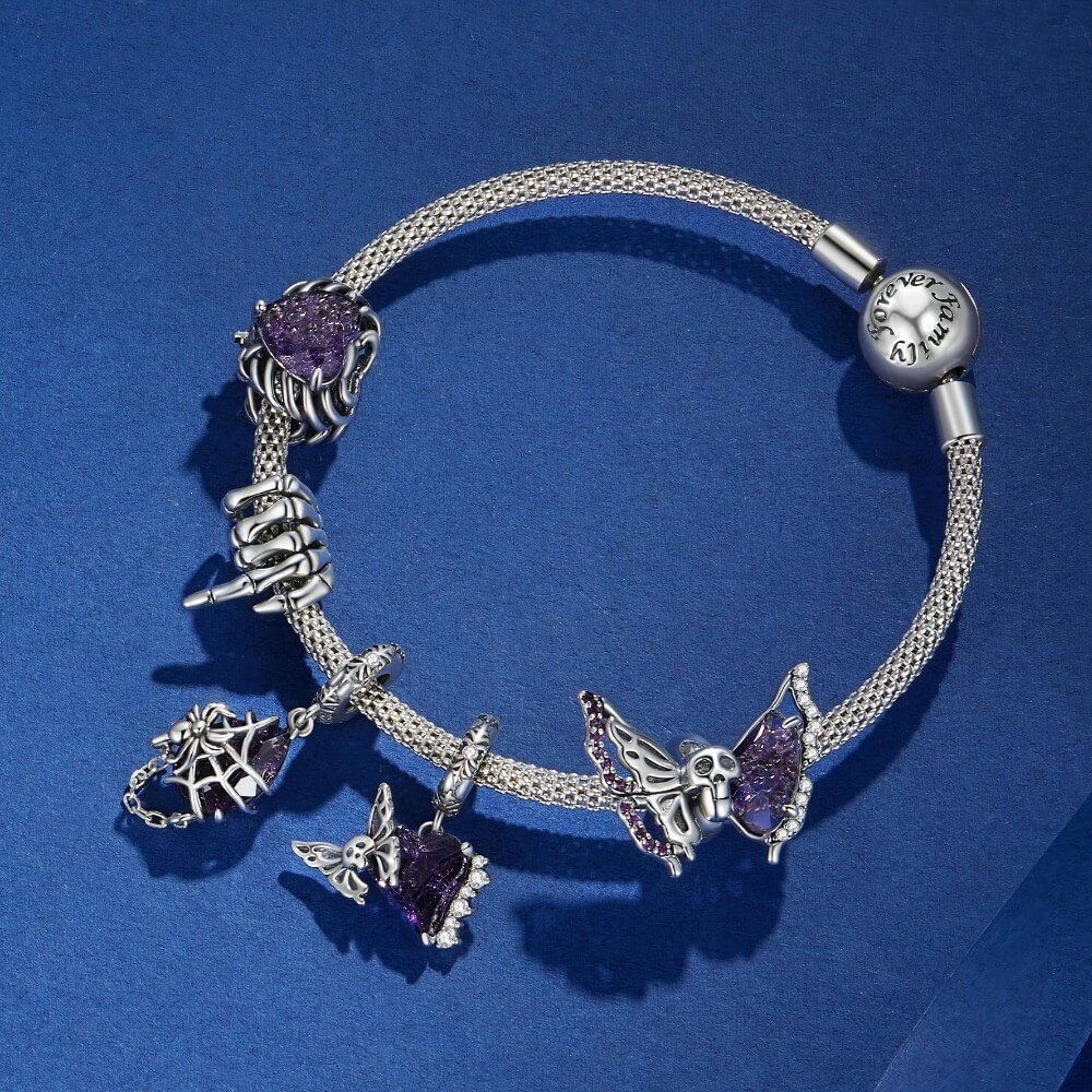 A silver charm bracelet with butterfly and spider motifs, featuring purple crystal accents, displayed on a textured blue background.