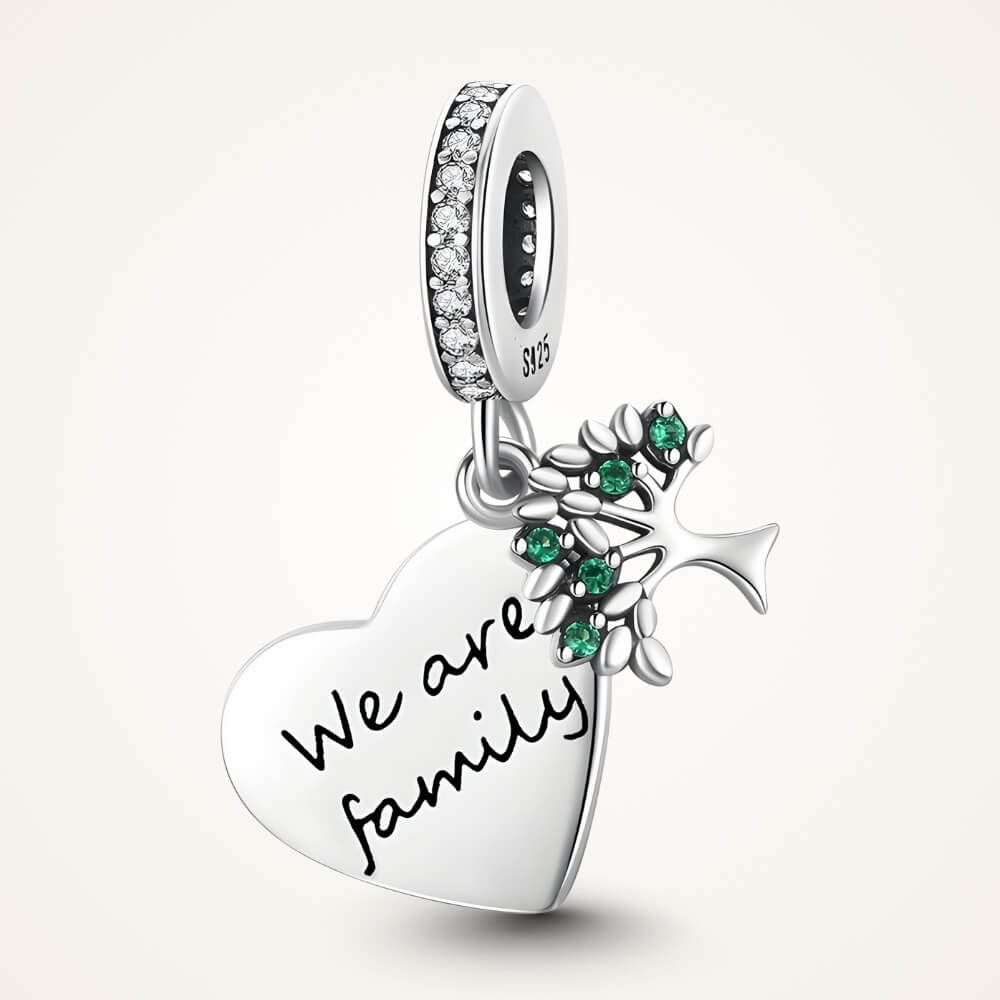 Sterling silver heart charm engraved “We are family” with green gemstones and cross detail - ORÉYA