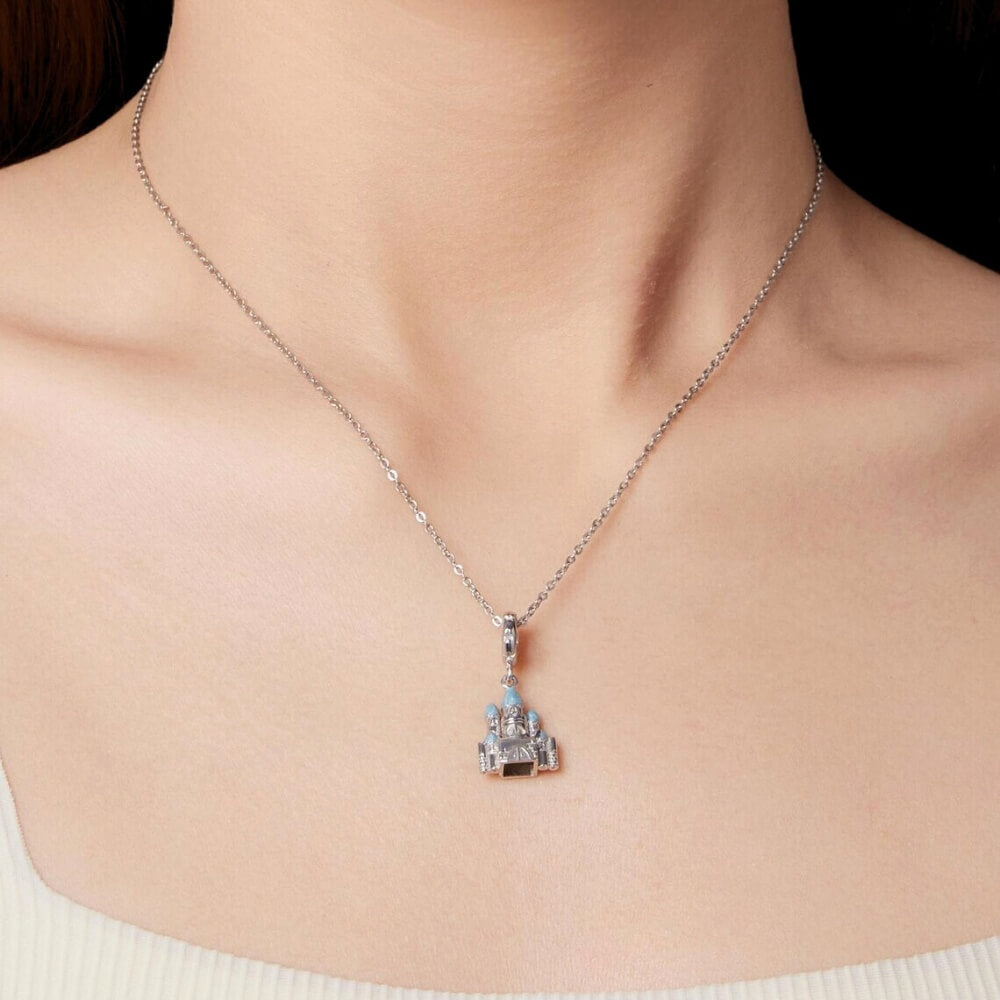 Sterling silver winter castle charm with icy blue enamel rooftops.