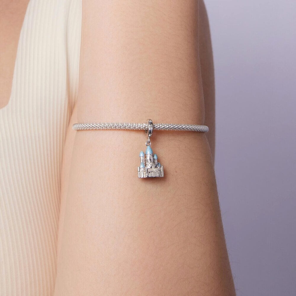 Sterling silver winter castle charm with icy blue enamel rooftops.