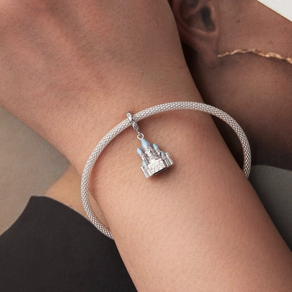 Sterling silver winter castle charm with icy blue enamel rooftops.