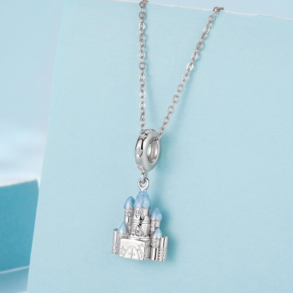 Sterling silver winter castle charm with icy blue enamel rooftops.
