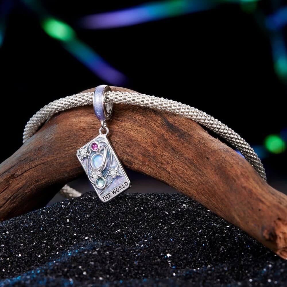 Sterling silver World tarot charm with lavender enamel, opal planet, stars, and colorful crystal details.