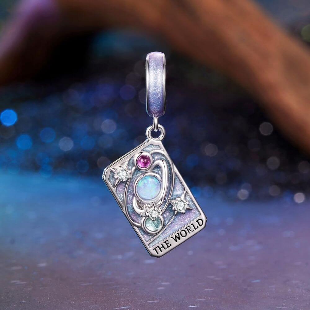 Sterling silver World tarot charm with lavender enamel, opal planet, stars, and colorful crystal details.