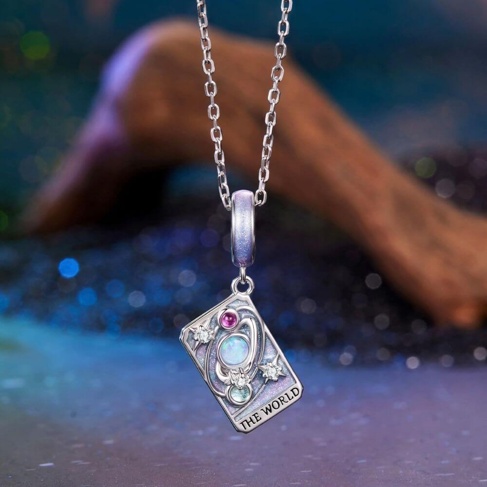 Sterling silver World tarot charm with lavender enamel, opal planet, stars, and colorful crystal details.