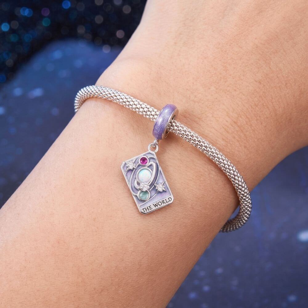 Sterling silver World tarot charm with lavender enamel, opal planet, stars, and colorful crystal details.