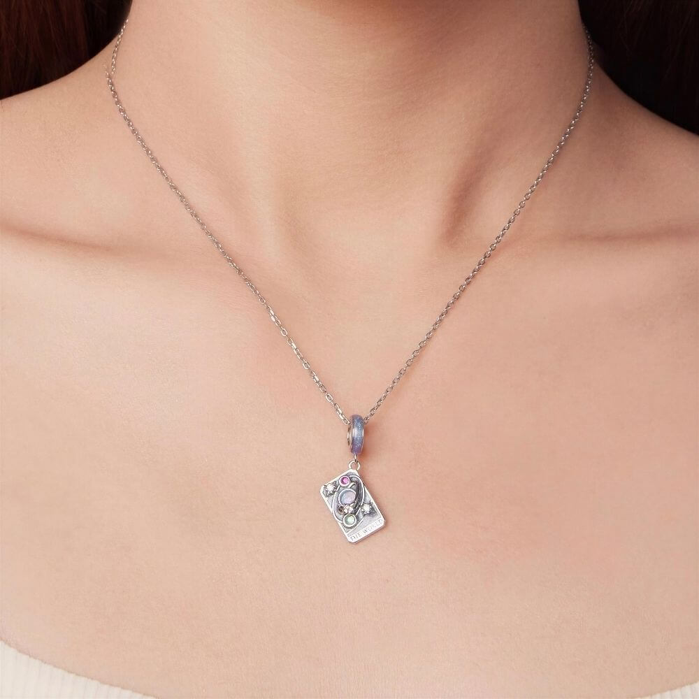 Sterling silver World tarot charm with lavender enamel, opal planet, stars, and colorful crystal details.